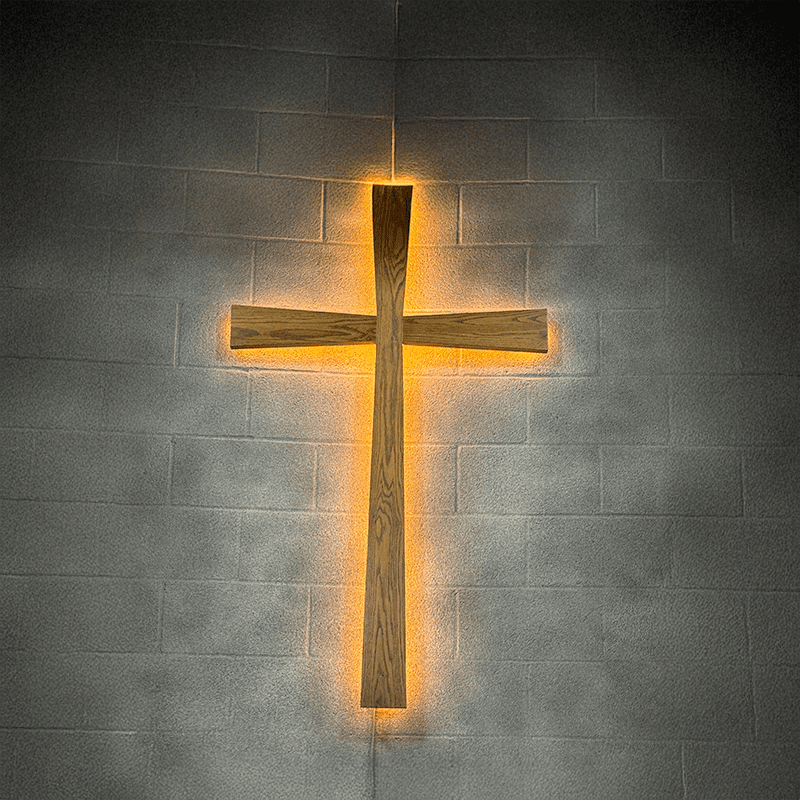 llbc-cross An image of a cross lit from behind on a gray brick wall
